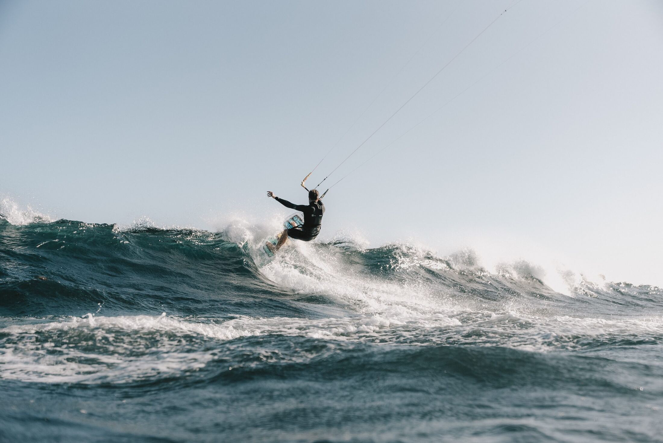 A kitesurfer riding a wave